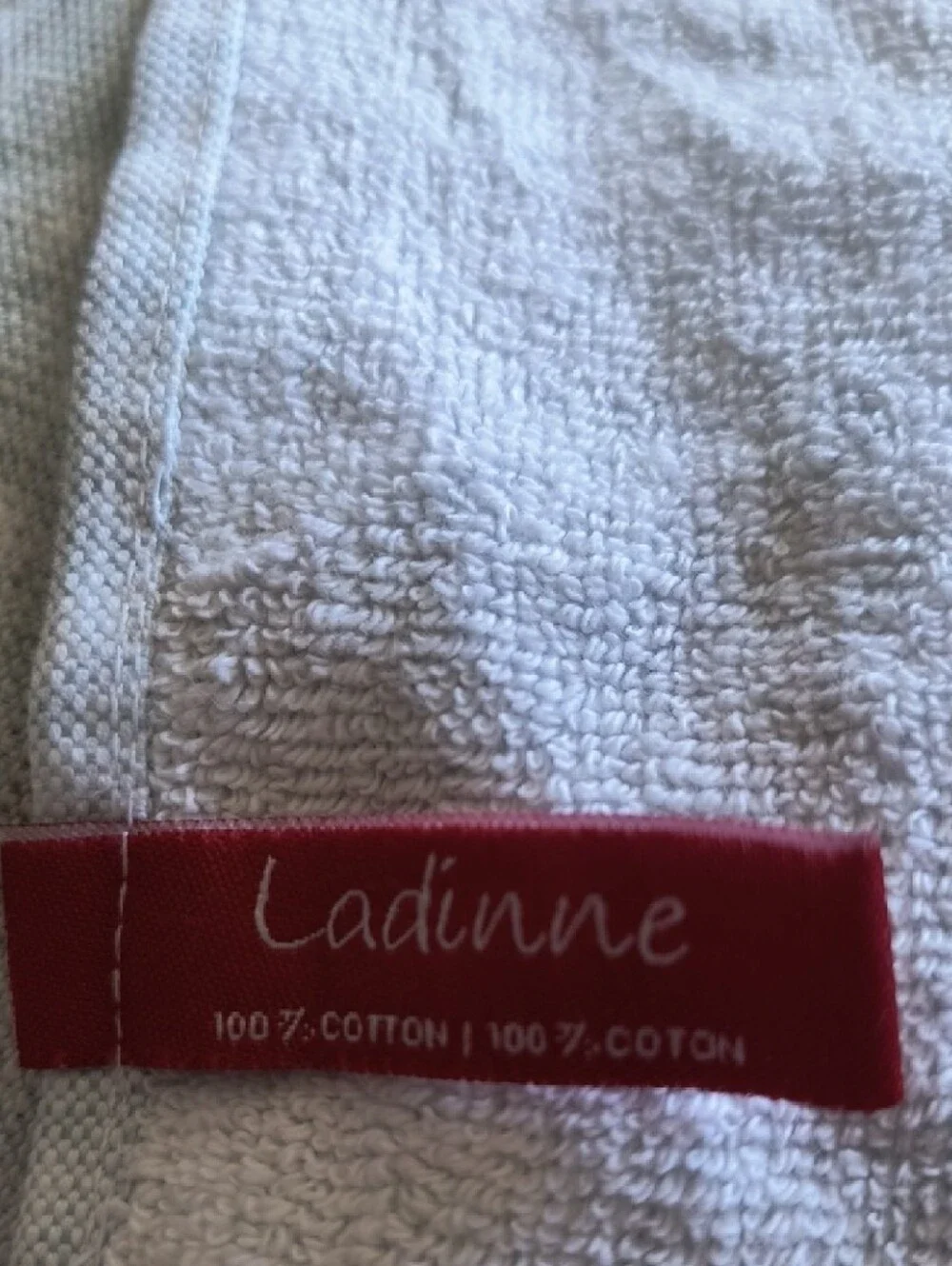 Ladinne Ivory Cotton Towel with Red Logo Tag